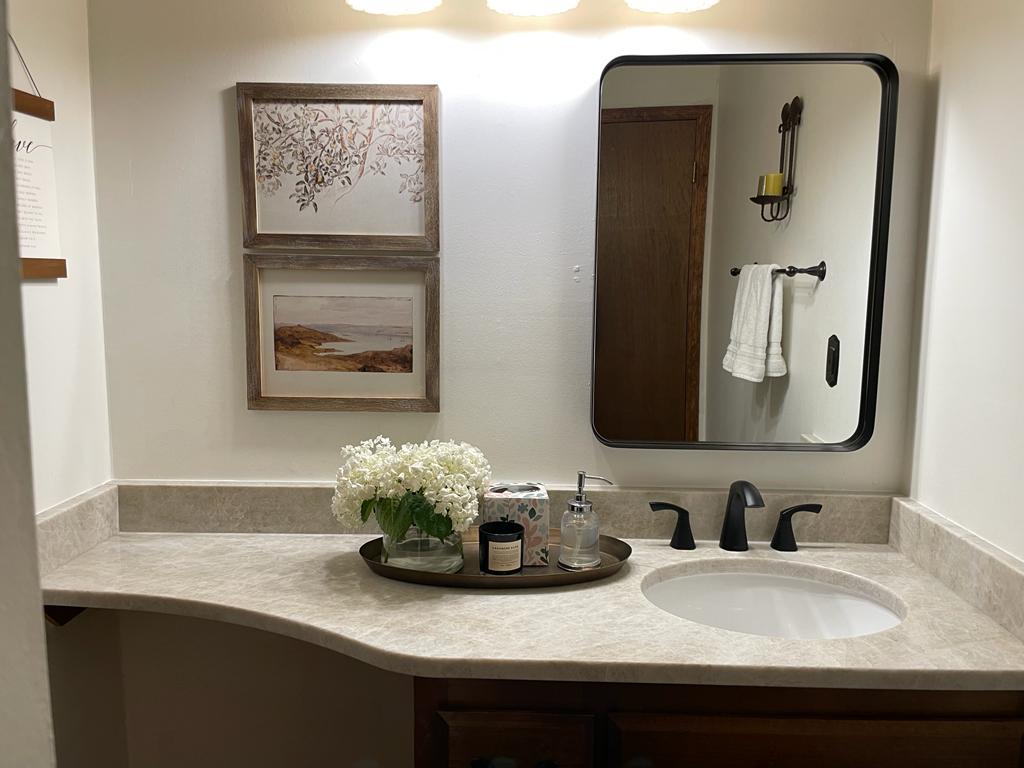 A Taj Mahal quartzite bathroom vanity using the original cabinetry. 