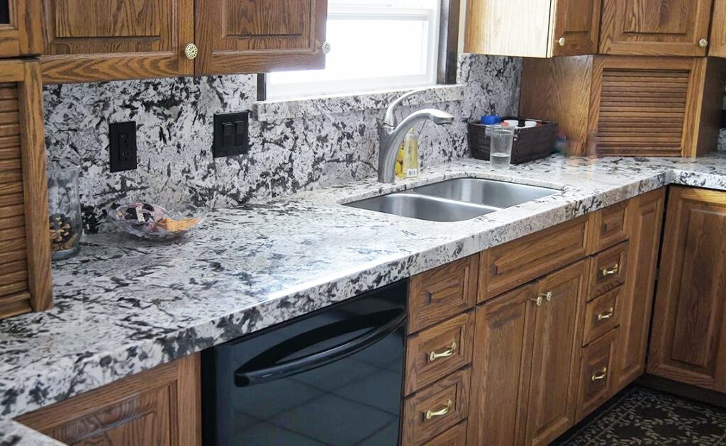 Pictured is a granite kitchen with all the options! Choosing the right countertop material goes beyond just the tops themselves: Granite countertops, backsplash, and windowsill. 