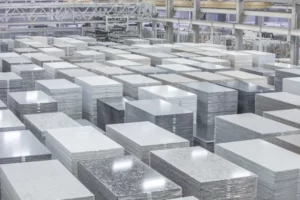 Quartz countertop slabs at a modern fabrication facility, showing stacks of polished engineered stone ready for cutting and finishing.
