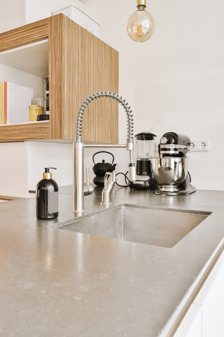 Modern kitchen quartz counter with appliances.