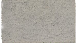 Close-up of a Dallas White granite slab showing its soft white background with subtle gray veining and burgundy specks.