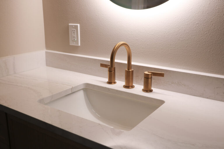 Everleigh quartz bathroom vanity with soft gray veining, undermount sink and brushed gold faucet