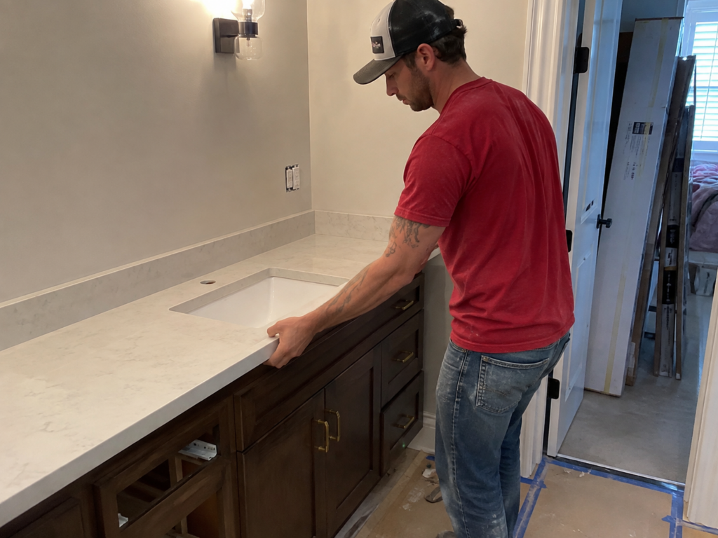 Man installing pre fabricated vanity