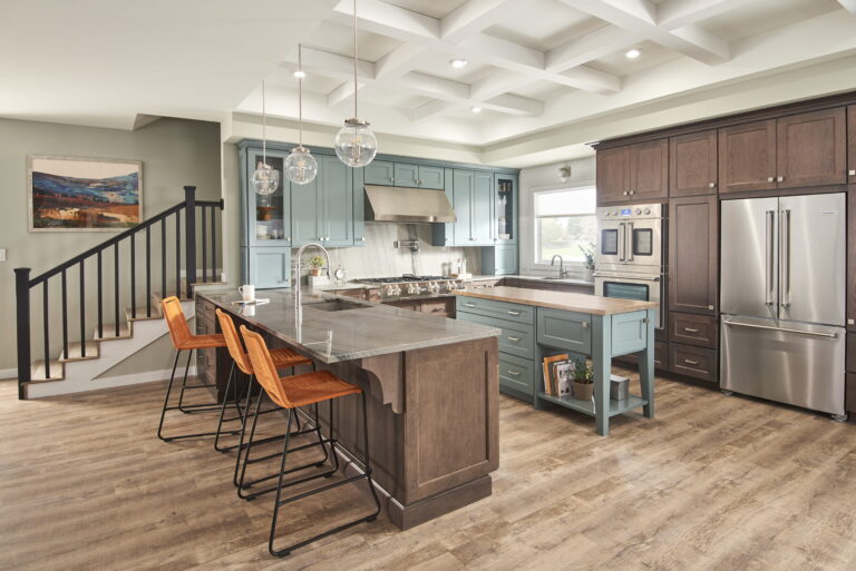 Audacia quartzite kitchen island in warm gray with seating, coffered ceiling and two-tone cabinets