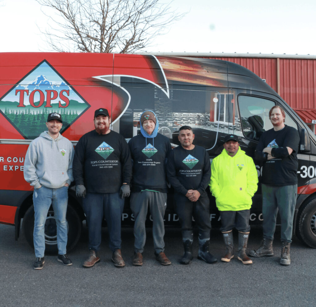 Tops Countertops fabrication team standing in front of a red Tops work van