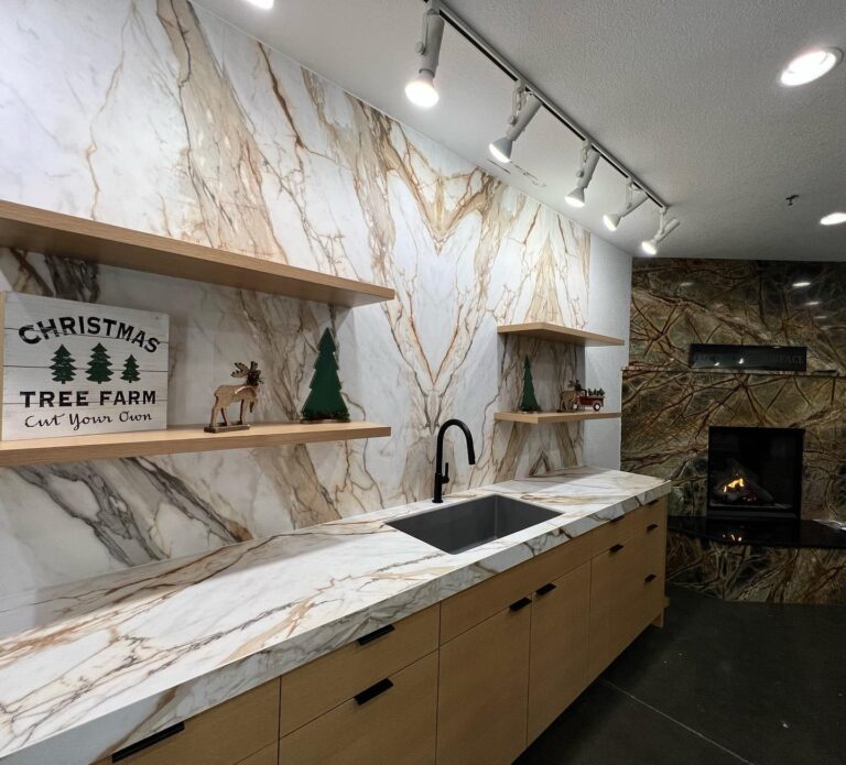Showroom display with white and gold-veined porcelain countertop and full-height backsplash, wood cabinets