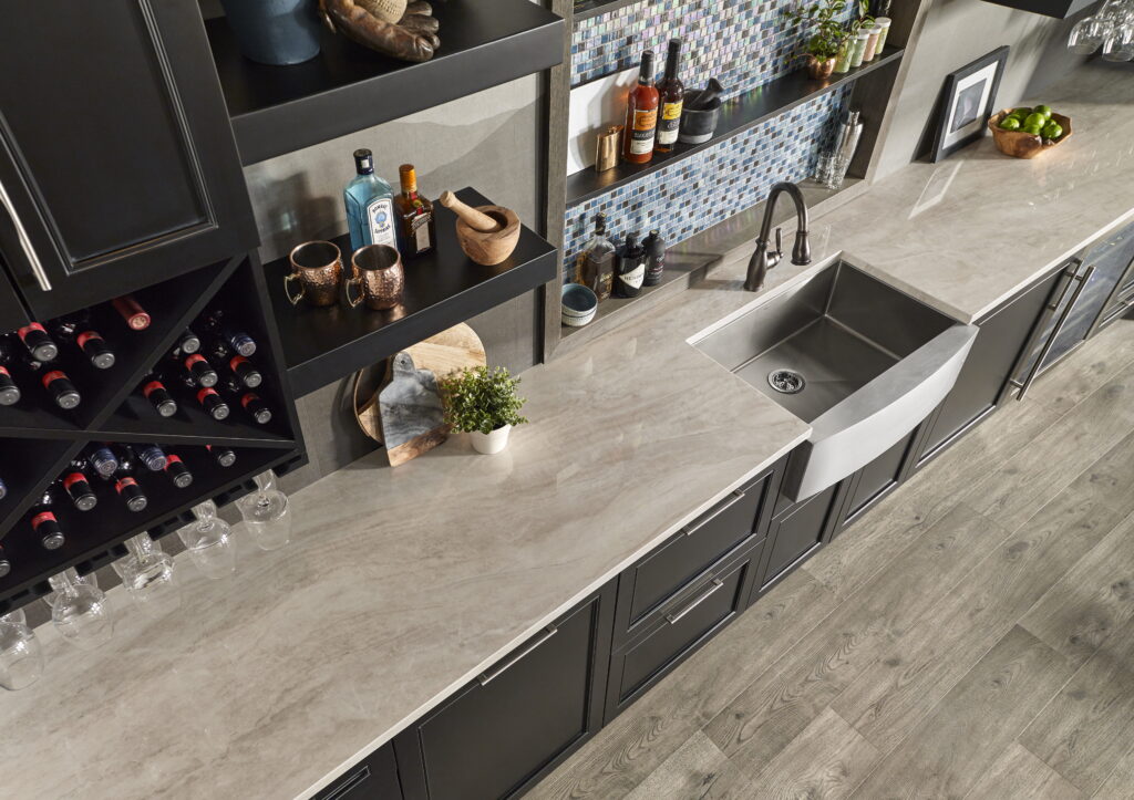 Taj Perla 12mm porcelain countertop in soft taupe with stainless farmhouse sink and wine rack