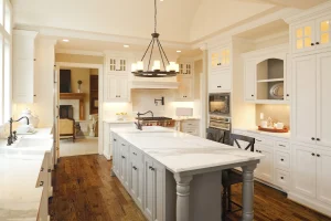White Calacatta marble countertops with a gray island and white subway tile backsplash