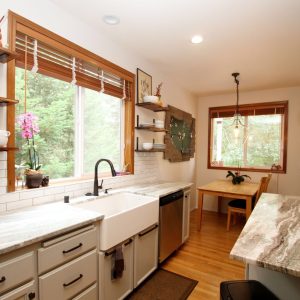 A fantasy brown granite kitchen with a farm sink located in Lacey Washington