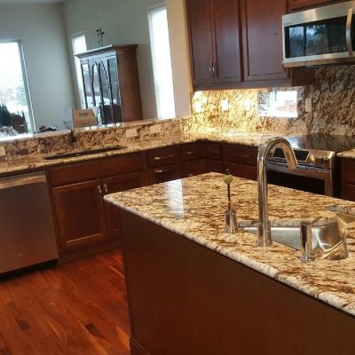 Granite countertops with dark wood cabinets.