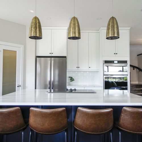 Chic modern kitchen with white quartz countertops, white